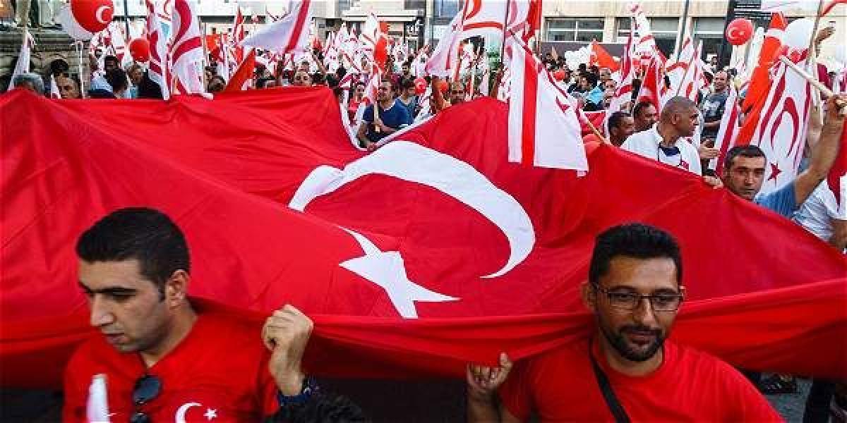 Un grupo de manifestantes que apoya al gobierno del presidente Tayyip Erdogan ondea una gran bandera en la plaza Taksim Square, en el centro de Estambul. Reuters