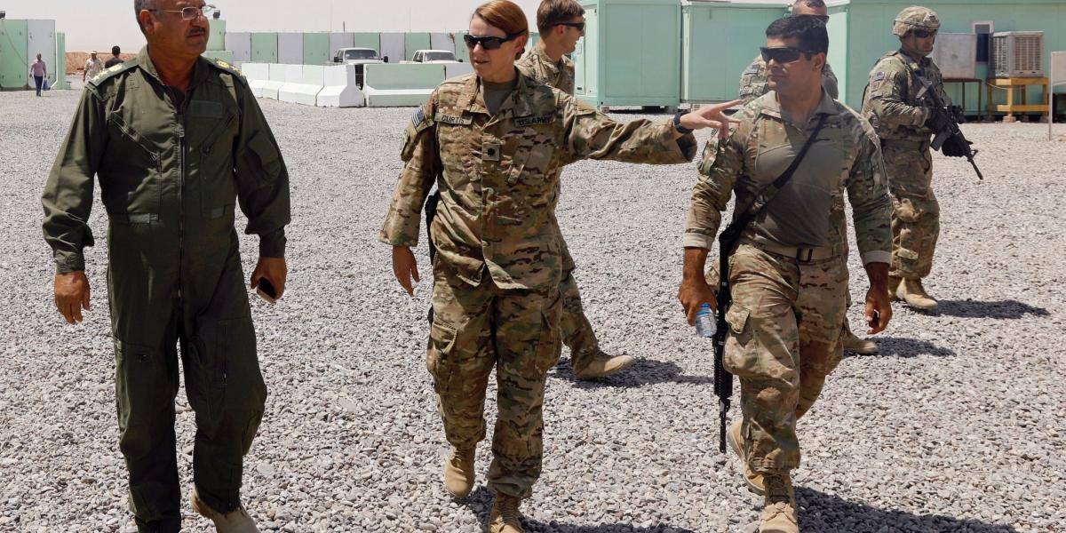 U.S. and Iraqi army officers walk inside an Iraqi army base at Qayyara west of Mosul, Iraq, August 10, 2017.