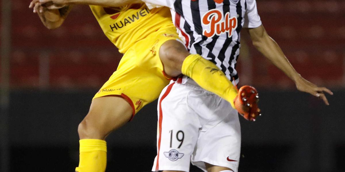 Jesús Medina (der.), de Libertad, disputa el balón con Juan Roa (izq.), en una acción del partido de ida de los octavos de final de la Copa Suramericana, disputado en el estadio Defensores Del Chaco en Asunción.