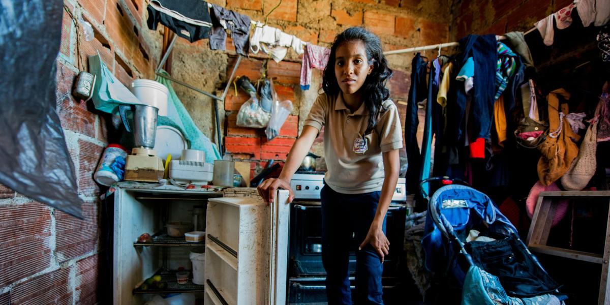 Rebeca León, quien tiene que buscar comida en la basura de Caracas, muestra la nevera de su casa, en el vecindario marginal de Petare.