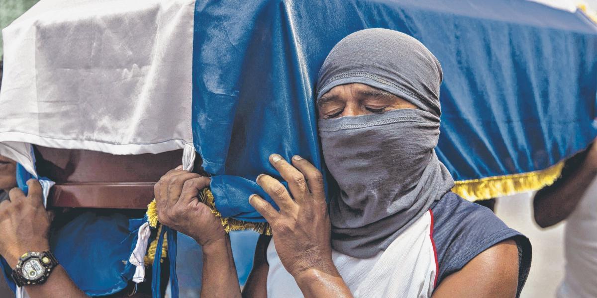 En la foto, un hombre carga el ataúd de José Medina, quien falleció durante un enfrentamiento contra parapolicías en Masaya.
