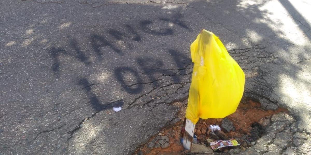La ciudadanía se unió a la manifestación pintando sobre el asfalto deteriorado los nombres de los concejales.