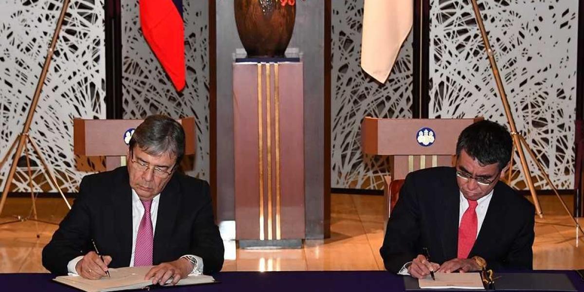 El canciller Carlos Holmes Trujillo firmando el acuerdo que pone fin a la doble tributación entre Colombia y Japón.