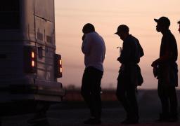 Migrantes esperando abordar un autobús en Arizona después de cruzar desde México.