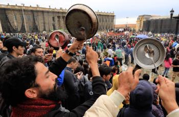 Manifestantes golpean sus cacerolas en la plaza de Bolívar de Bogotá.