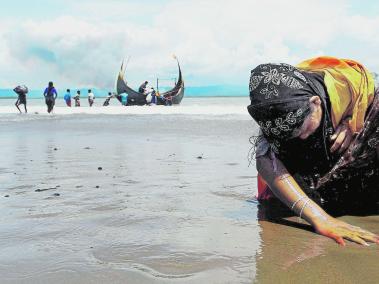 El drama de los refugiados Rohinyás. Una refugiada de esta etnia musulmana toca la orilla después de cruzar de Birmania a Bangladés, por la bahía de Bengala, debido a la ola de violencia en el primer país.