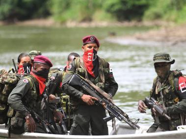 Rebels of the National Liberation Army (ELN) take a rest near the Baudo river in Choco province, Colombia on October 26, 2023. In the jungle that is home to Colombia's most powerful guerrilla group, the law of arms continues to reign, despite ongoing negotiations with the government.