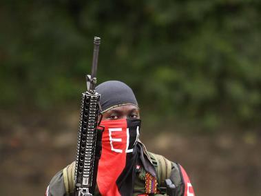 Rebels of the National Liberation Army (ELN) take a rest near the Baudo river in Choco province, Colombia on October 26, 2023. In the jungle that is home to Colombia's most powerful guerrilla group, the law of arms continues to reign, despite ongoing negotiations with the government.