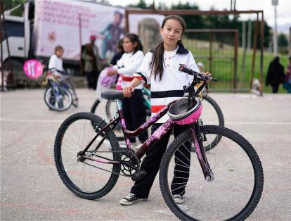Carol con su nueva bicicleta, que utilizará para ir de su casa al colegio y del colegio a su casa.