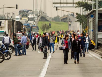Sobre el carril preferencial por donde pasan buses articulados hacia la estación San Mateo, en Soacha, así como hacia el portal Sur, en Bogotá, permanece un grupo de pasajeros de TransMilenio que impide el paso de los vehículos.