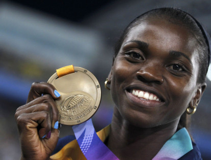 Bronze medalist Caterine Ibarguen of Colombia reacts on the podium after the women's triple jump event at the IAAF World Championships in Daegu September 1, 2011.