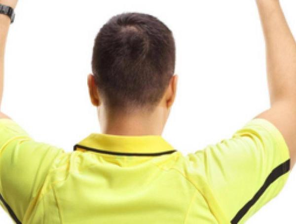 Arbitro pita con tobillera electrónica.