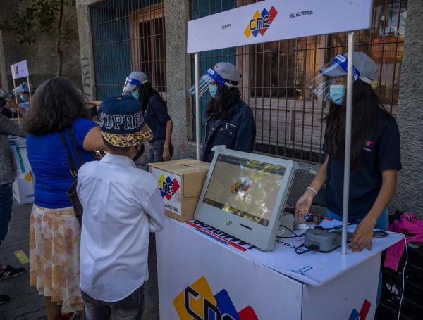 Funcionarios del Consejo Nacional Electoral (CNE) venezolano realizan un tutorial de voto para los ciudadanos, el 11 de noviembre de 2021 en Caracas (Venezuela).