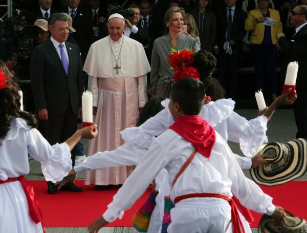 El papa Francisco observa la presentación de un grupo de danza folclórica durante su recibimiento en la base aérea de Catam