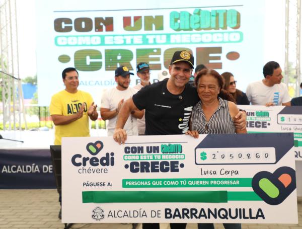 El alcalde de Barranquilla, Alejandro Char,  entregando uno de los créditos a un comerciante.