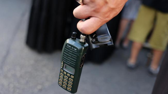 Un hombre sostiene un walkie talkie Icom después de haberle quitado la batería en Líbano.