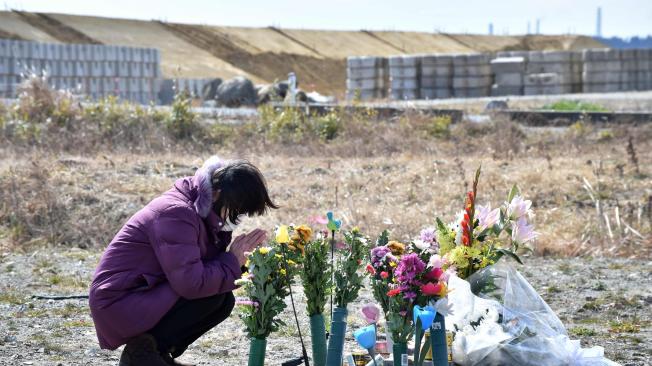 Una mujer ruega por las víctimas del desastre del terremoto-tsunami de 2011 en Namie, una zona sin entrada en la provincia de Fukushima.
