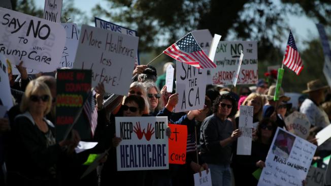 Manifestantes protestan por la derogación y reemplazo de Obamacare, frente a la oficina del congresista republicano Darryl Issa, en Vista, California.