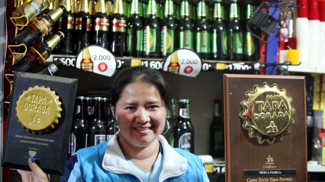 Estela Hernández, de Mercafamiliar, exhibe dos tapas doradas de Bavaria, título que se da a las tiendas que más venden cerveza.
