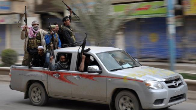 Un grupo de rebeldes sirios festeja haber tomado casi todo el control de Raqa en marzo de 2013.