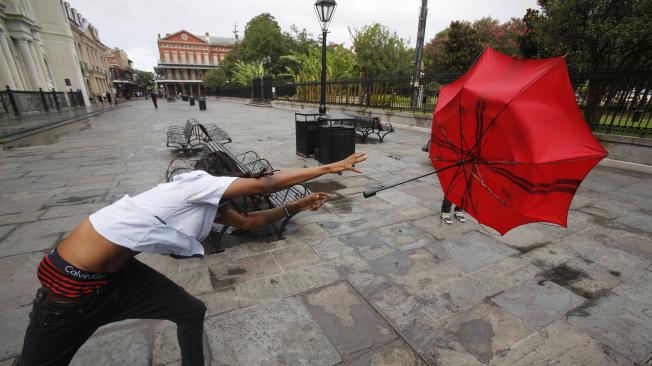 A man in the French Quarter plays with his umbrella in the wind of Tropical Storm Barry in New Orleans