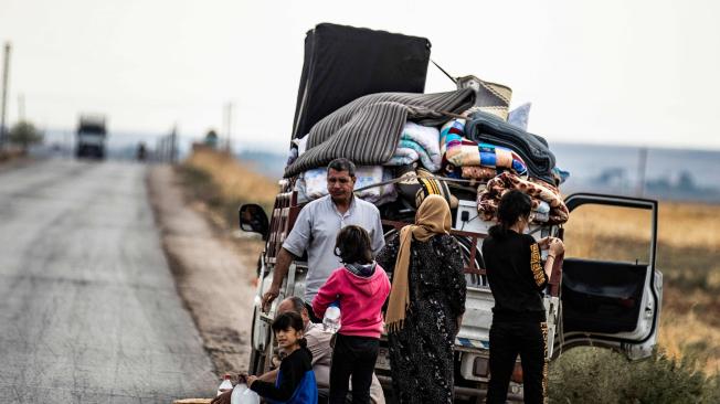 Familias sirias kurdas y árabes huyendo del campo en ciudad de Darbasiyah, en frontera entre Siria y Turquía.