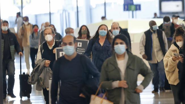 Los viajeros con mascarillas acceden al Aeropuerto Internacional LAX Tom Bradley en medio de la pandemia de covid-19 en Los Ángeles, California, EE. UU., 24 de noviembre de 2020.