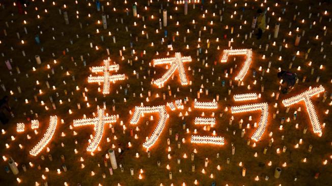 Lit candles form characters that read "memory" and "connecting future" at the Great East Japan Earthquake and Nuclear Disaster Memorial Museum in Futaba town, Fukushima prefecture.
