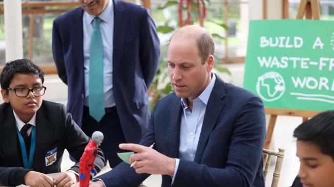 Britain's Prince William, Duke of Cambridge interacts with children from The Heathlands School, Hounslow during a visit to take part in a Generation Earthshot educational initiative comprising of activities designed to generate ideas to repair the planet and spark enthusiasm for the natural world, at Kew Gardens, London on October 13, 2021