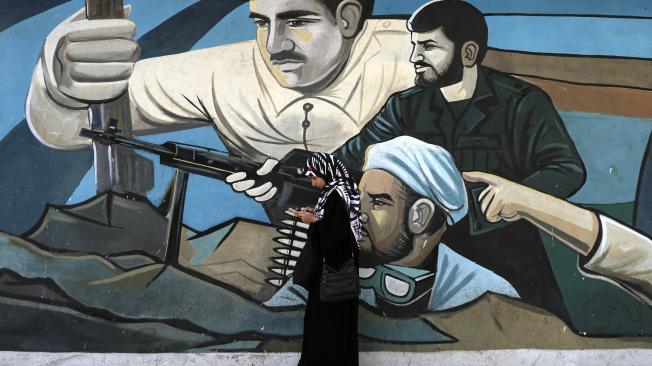 An Iranian woman stands in front of a mural depicting Iranian revolutionary soldiers at Palestine Square in Tehran, Iran, 09 September 2024.