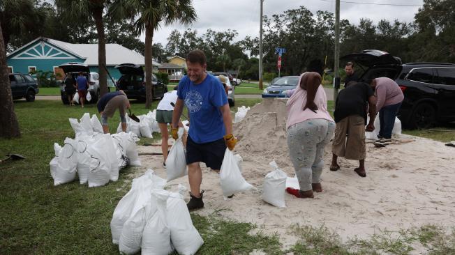 La gente llena sacos de arena mientras Florida se prepara para la llegada del huracán Milton.