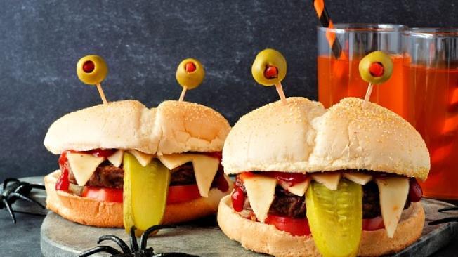 Halloween monster hamburgers, scene against a black backgroun