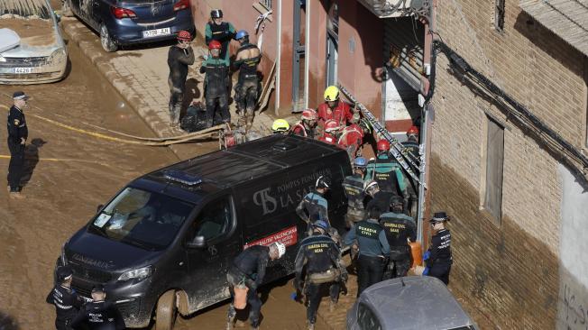 VALENCIA, 31/10/2024.- Guardias civiles y policías locales acceden al interior de un garaje en el barrio valenciano de La Torre, en búsqueda de posibles fallecidos, este jueves. La Comunitat Valenciana intenta recuperarse de la peor DANA del siglo en España, que ha dejado casi un centenar de muertos en esa región, además de un inmenso escenario de daños en carreteras, calles e infraestructuras de numerosas localidades. EFE/ Biel Aliño