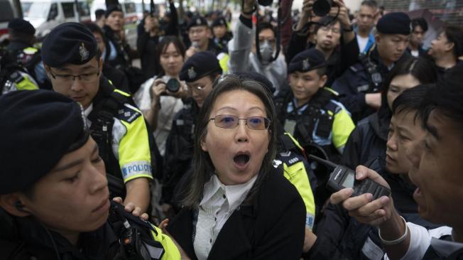 Hong Kong (China), 19/11/2024.- A woman is stopped by the police outside of the West Kowloon Magistrates' Court in Hong Kong, China, 19 November 2024. Out of the 47 Hong Kong pro-democracy activists arrested in 2021, 45 were sentenced in the city's largest national security trial. EFE/EPA/LEUNG MAN HEI