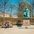 Copenhagen, Denmark - 29 April, 2023: tourists next to a statue of Hans Christian Andersen, one of the most famous Danish authors, in a park in central Copenhagen, Denmark.