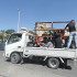 A Syrian family sit with their belongings in the back of a truck as they wait in a traffic jam in the southern Lebanese city of Sidon on September 23, 2024. The Israeli military on September 23 told people in Lebanon to move away from Hezbollah targets and vowed to carry out more "extensive and precise" strikes against the Iran-backed group. (Photo by Mahmoud ZAYYAT / AFP)