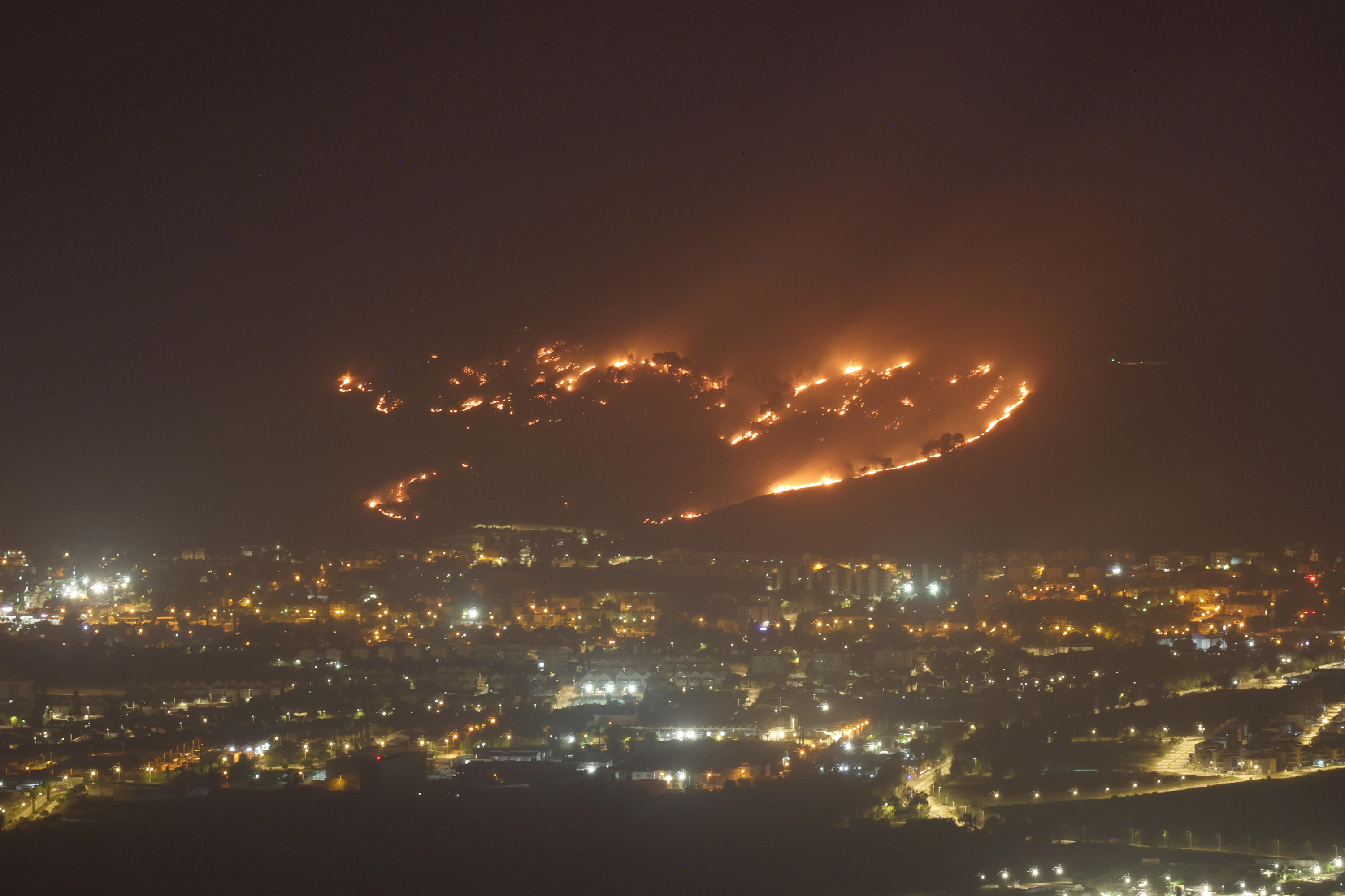 A fire breaks out from a downed missile fired from southern Lebanon, next to the town of Kiryat Shmona, near the Israel-Lebanon border,