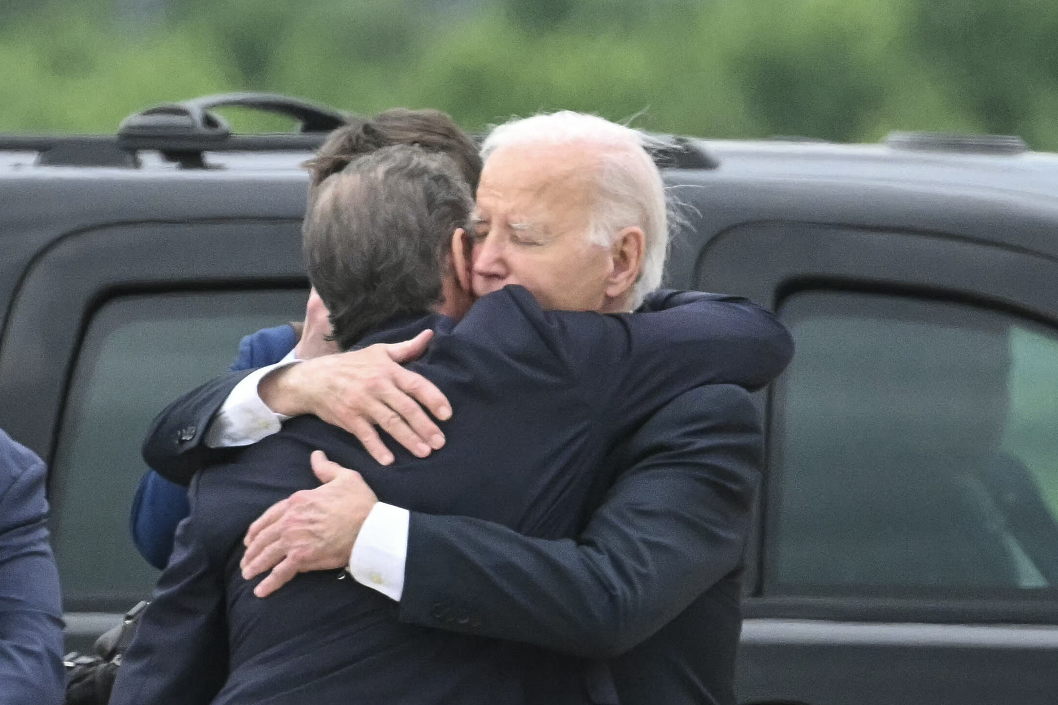 US President Joe Biden hugs his son Hunter Biden upon arrival at the Delaware Air National Guard Base.