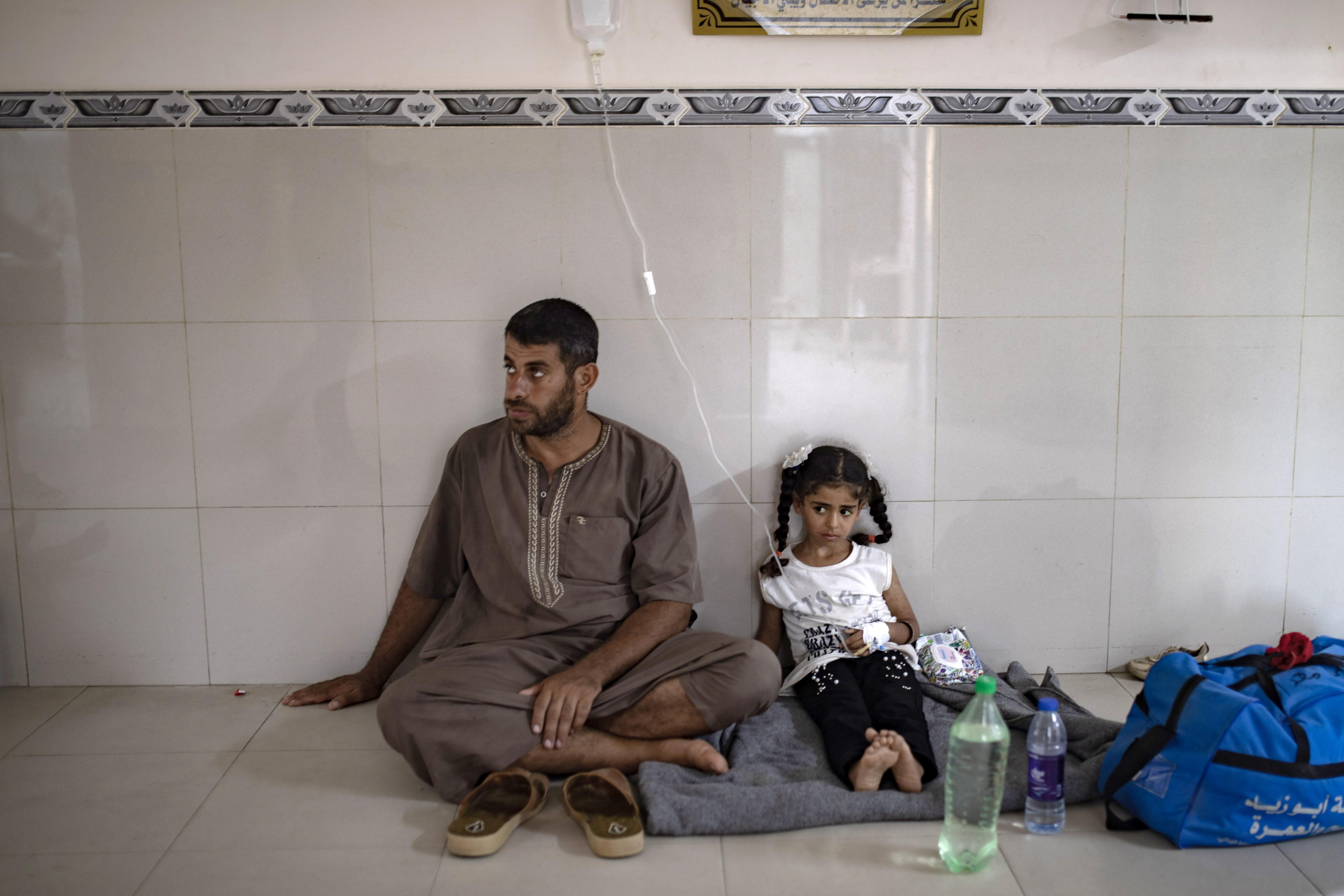 A Palestinian girl suffering from malnutrition sits on the floor on a blanket at Nasser Hospital in Khan Yunis, southern Gaza Strip, July 8, 2024.