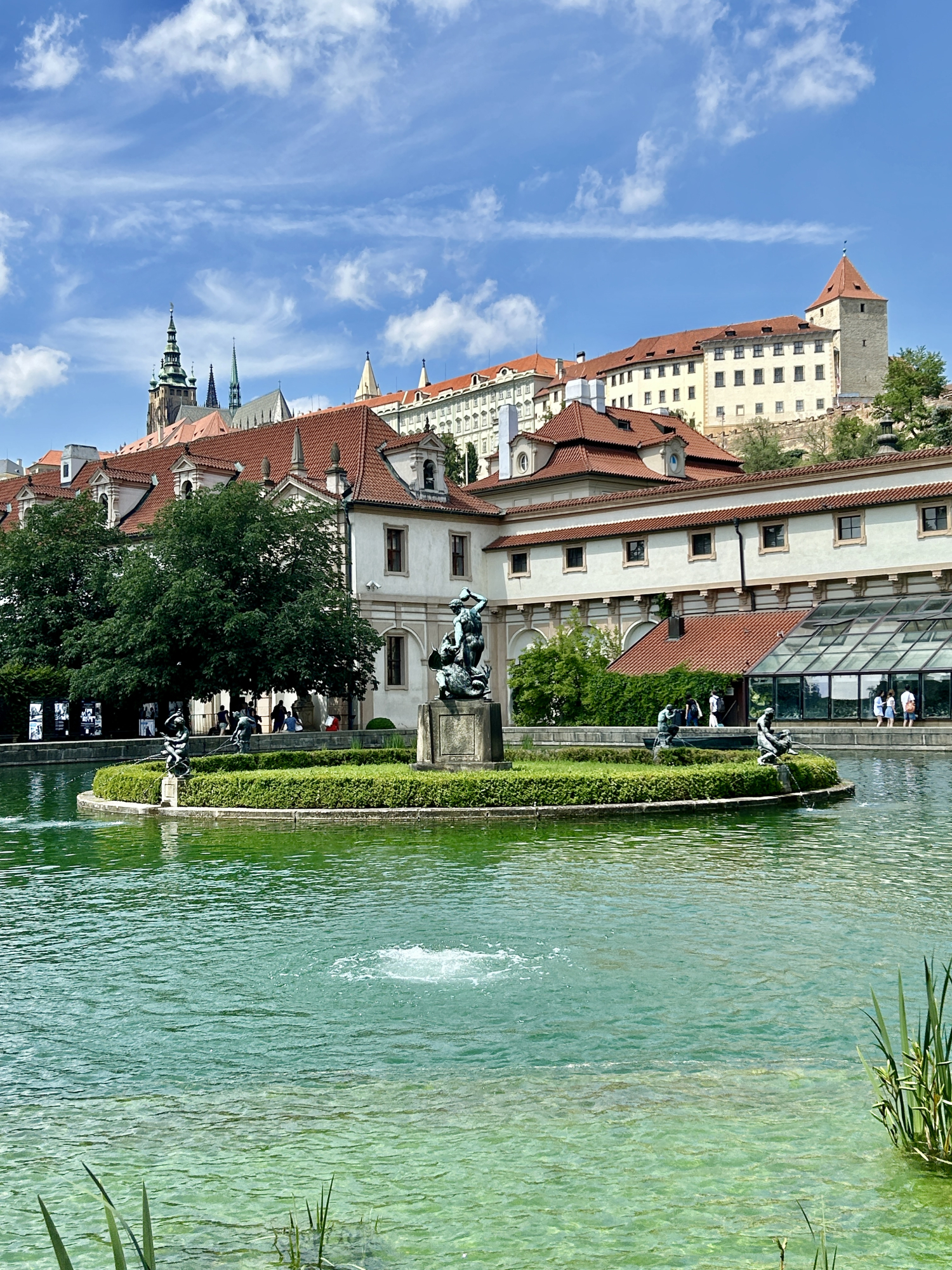 Gardens and fountains adorn the city. In the background, Prague Castle.