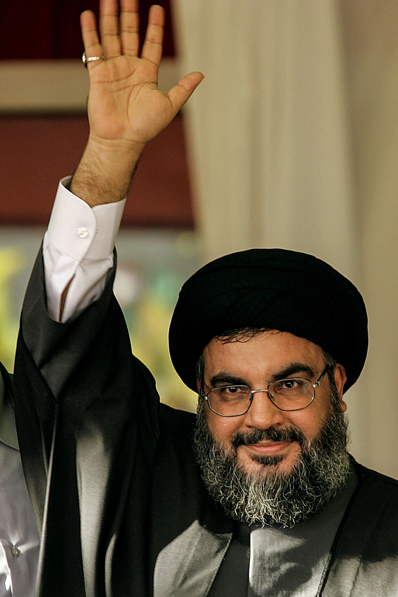 Hezbollah chief Hassan Nasrallah greets the crowd at a rally in 2006.